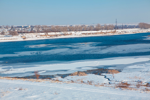winter landscape , river with frozen shore