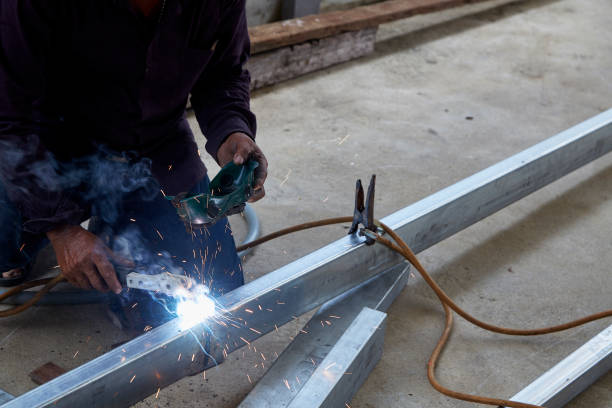 istock Asian worker making sparks while welding steel 1152781141