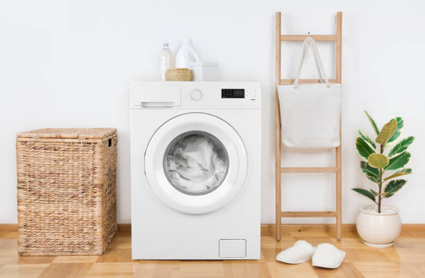 istock Modern washing machine with basket in laundry room interior 1152782296