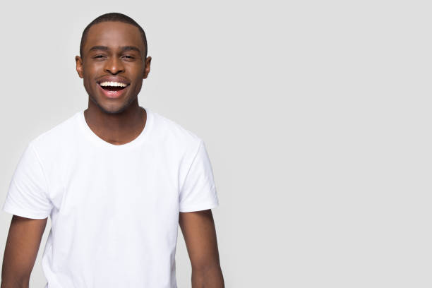 istock African man laughing looking at camera isolated on grey blank 1152782354