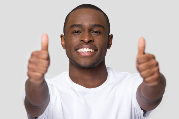 istock African man feels happy showing thumbs up looking at camera 1152782356