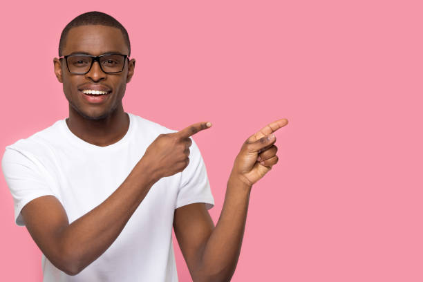 istock Handsome man in glasses looking at camera pointing aside 1152782389
