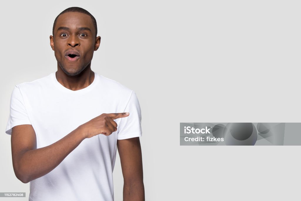 Surprised Funny African Man Pointing Aside Looking At Camera Stock Photo - Download Image Now - iStock Surprised Funny African Man Pointing Aside Looking At Camera Stock Photo - Download Image Now - iStock