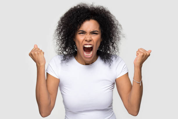 istock African mad woman looking at camera screaming studio shot 1152782422