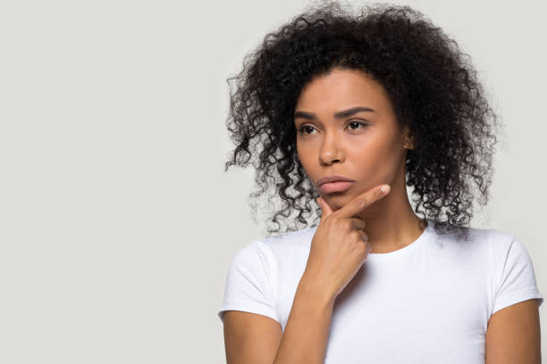 istock Thoughtful african woman thinking pose on grey wall looking aside 1152782429