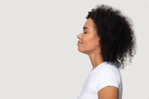 istock Side profile view african woman closed eyes dreaming 1152782449