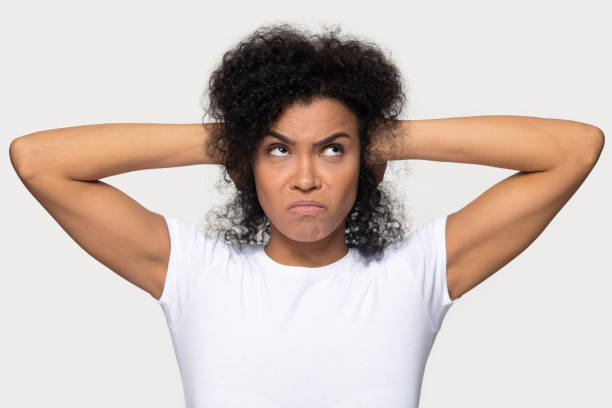 istock Angry african woman shut her ears with hands studio shot 1152782462