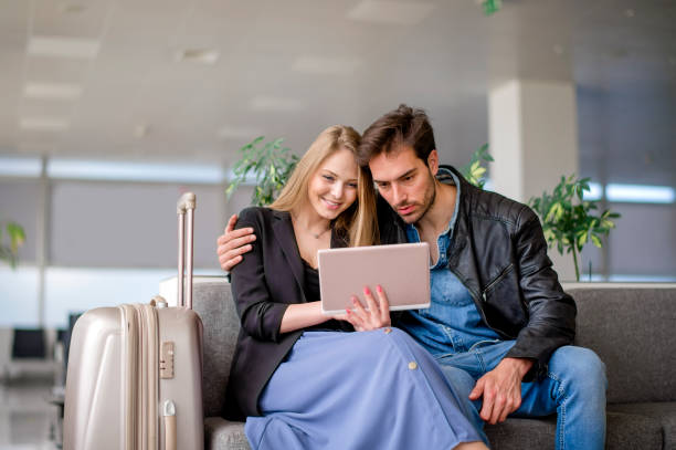 istock Young couple with digital tablet at the airport 1152784308