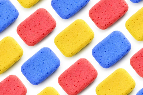 Pattern of colorful sponges for cleaning on white background Pattern of colorful sponges for cleaning on white background. Top view, flat lay porous sponge stock pictures, royalty-free photos & images