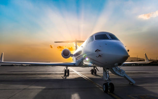 istock Business Jet on Ramp with Sun in Background 1152786697