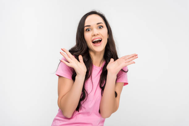 istock surprised girl standing and smiling isolated on grey 1152790395