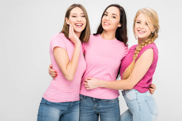 istock happy women standing and smiling isolated on grey 1152790485