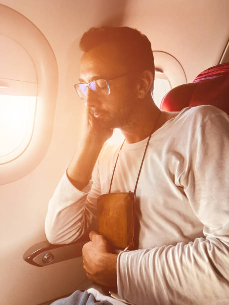 istock Airplane passenger with a neck bag for safe carrying money and documents. 1152797609