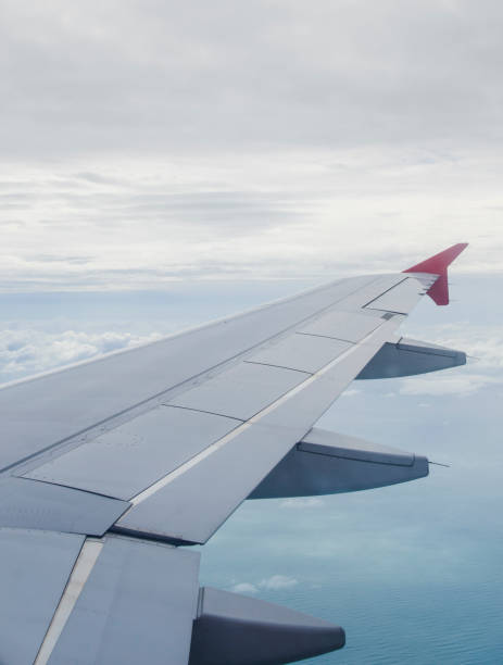 istock Cropped Airplane Wing Against Sky 1152798248