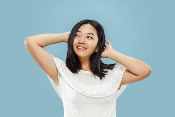 istock Korean young woman's half-length portrait on blue background 1152801722