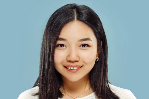 istock Korean young woman's close up portrait on blue background 1152801899