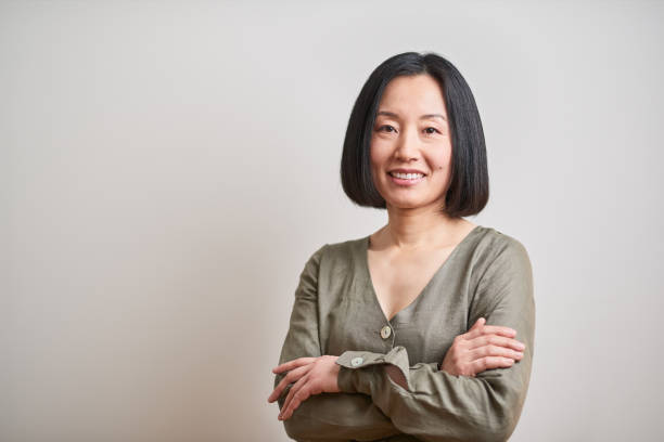 istock Business headshot, portrait looking at camera on gray background. 1152805730