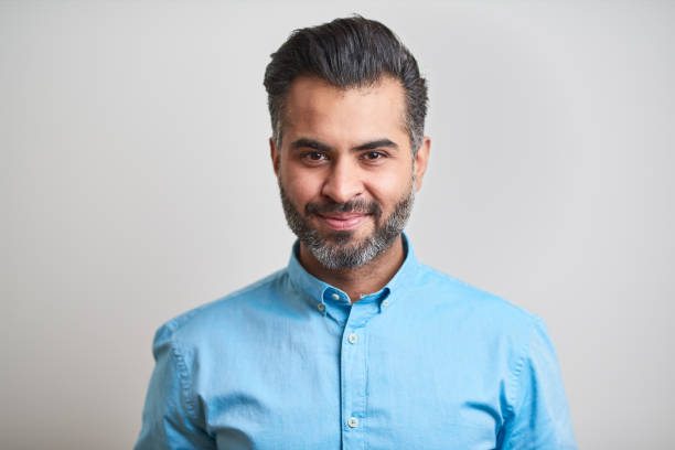 istock Business headshot, portrait looking at camera on gray background. 1152805738