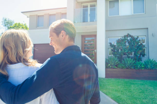istock Couple standing in front of their new home. 1152807313