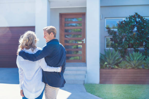 istock Couple standing in front of their new home 1152807314