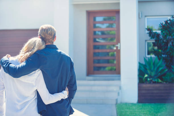 istock Couple standing in front of their new home. 1152807324