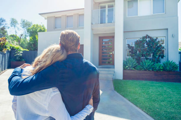 istock Couple standing in front of their new home. 1152807329