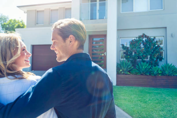 istock Couple standing in front of their new home. 1152807330