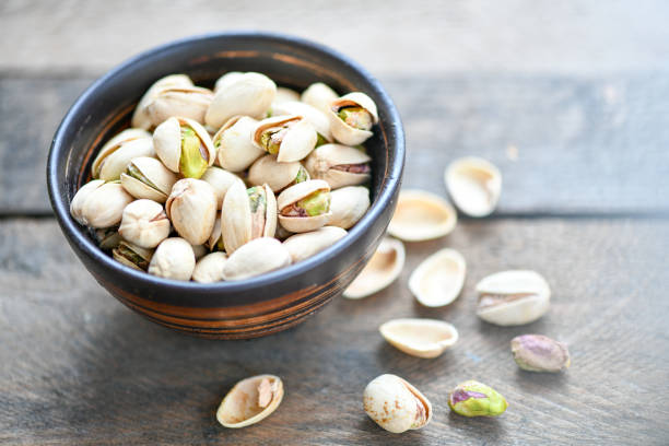 istock Pistachios nuts in wooden bowl 1152807483