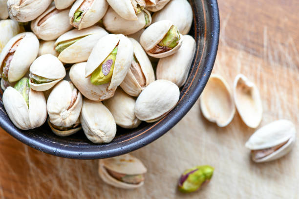 istock Pistachios nuts in wooden bowl 1152807581