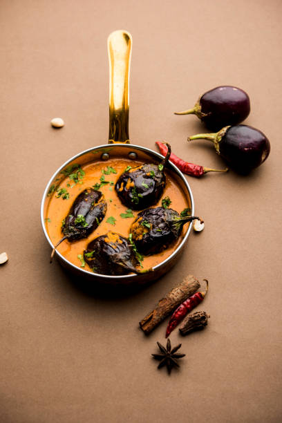 Baingan masala / Eggplant / brinjal curry served in bowl or pan, selective focus