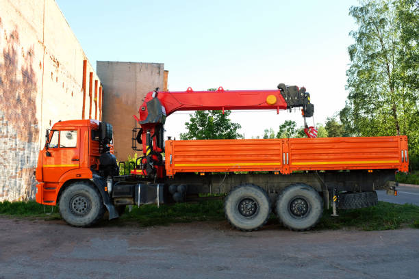 orange truck with a crane in the street