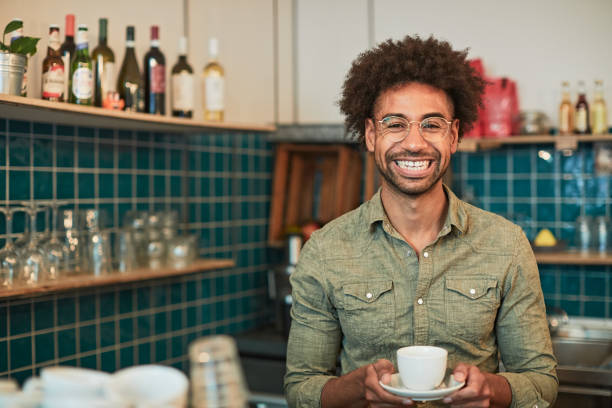 istock Coffee shop client looking at camera and holding a cup of coffee. 1152812080
