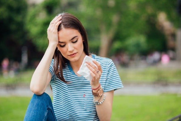 istock Girl holding handkerchief and hand on her head 1152812450