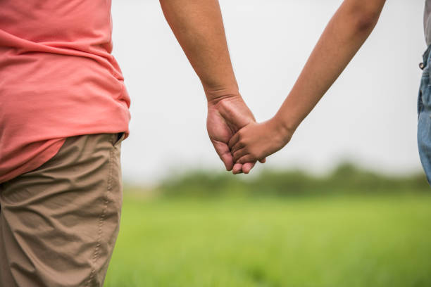 istock Father and daughter holding hand in hand together 1152812576
