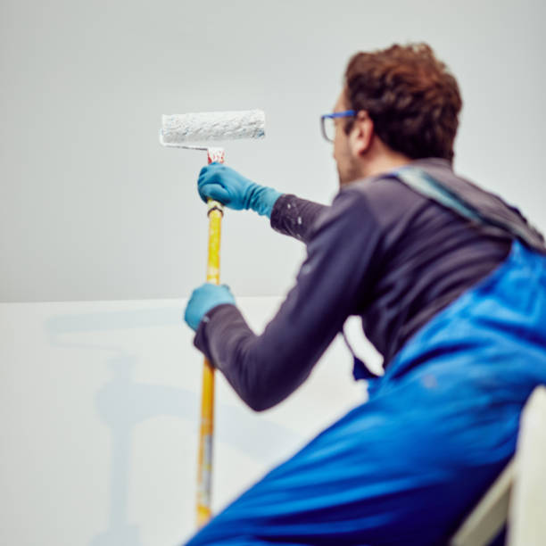 istock Worker painting walls inside the house - renovation fixes. 1152812669
