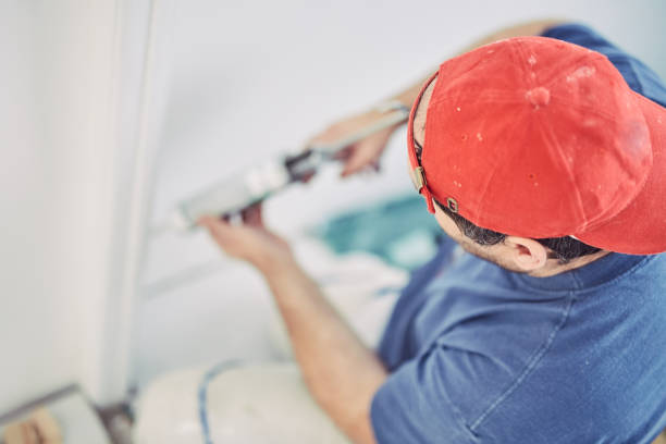 istock Worker using silicone for walls and tiles inside the house - renovation fixes. 1152814046
