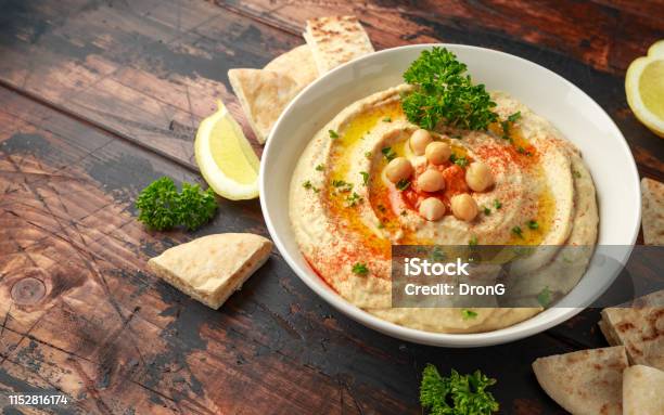 Hummus With Olive Oil Paprika Lemon And Pita Bread Stock Photo - Download Image Now