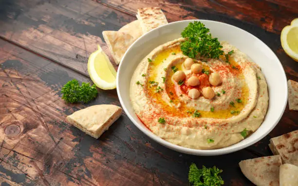 Hummus with olive oil, paprika, lemon and pita bread.