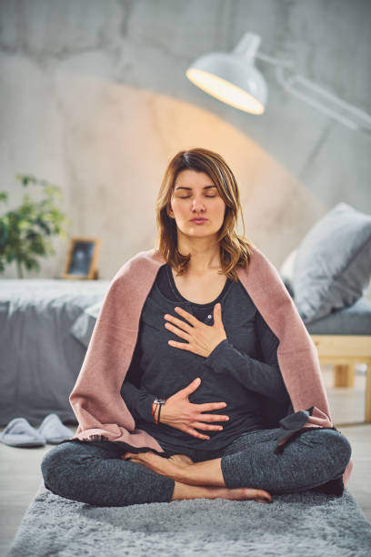 istock Woman meditating in bedroom. 1152817286