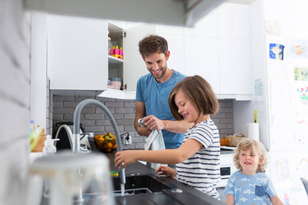 Father and sons washing dishes together