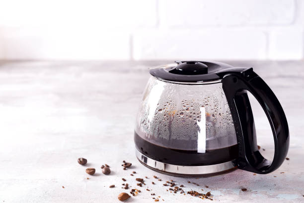 istock a filled coffee pot with coffee beans against a stone gray background, copy space 1152819157