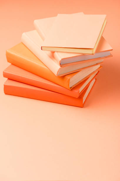 istock stack of colorful hardcover books on orange surface 1152821143