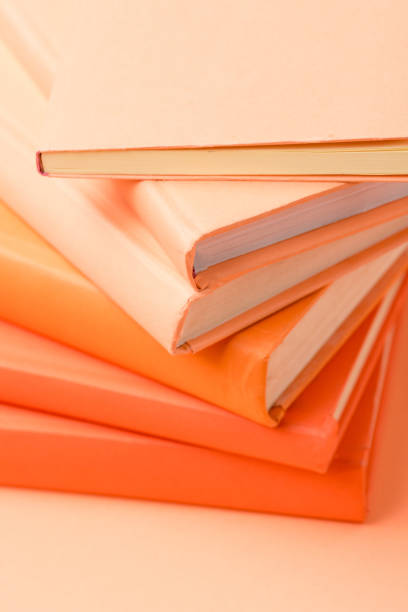 istock stack of colorful hardcover books on orange surface 1152821144