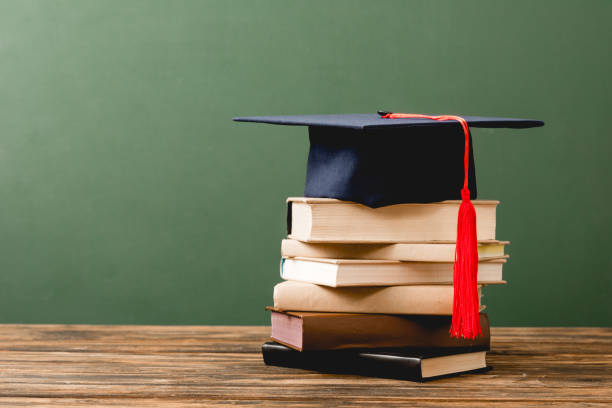 istock books and academic cap on wooden surface isolated on green 1152821215