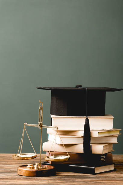 istock books, academic cap and scales on wooden surface isolated on grey 1152821271