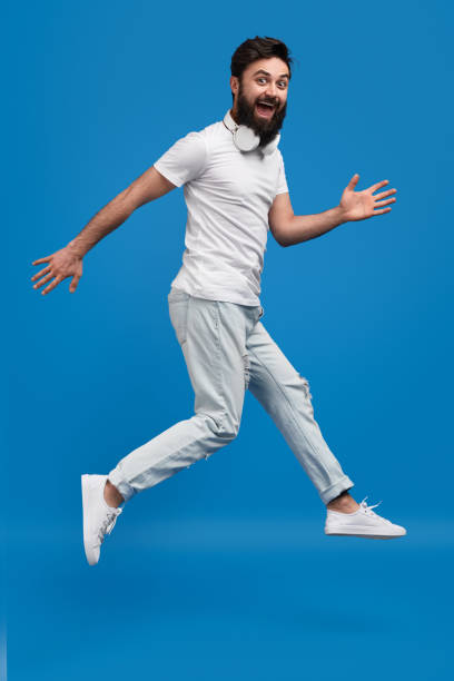 istock Cheerful hipster jumping and looking at camera 1152822879