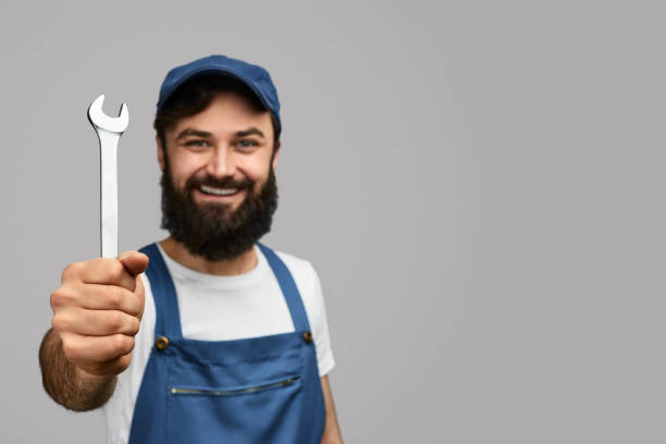 istock Cheerful repairman with wrench 1152823441