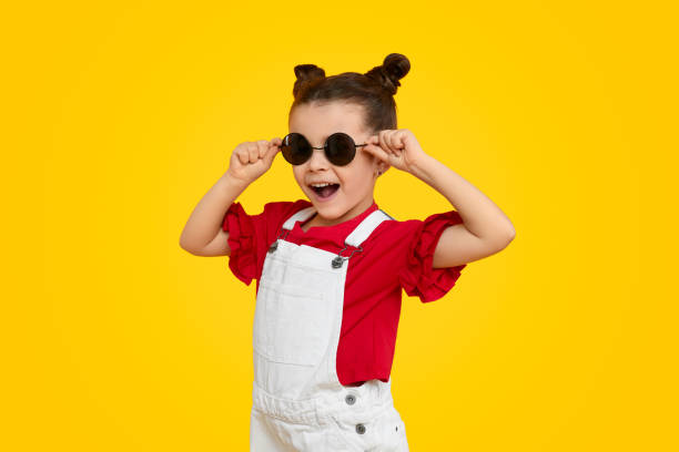 istock Cheerful kid model trying on stylish sunglasses 1152823443