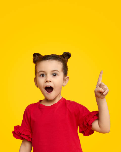 istock Surprised girl pointing up 1152823453