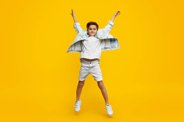 istock Boy raising hands and jumping 1152823463
